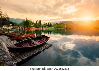 Traditional wooden boats Pletna on the backgorund of Church on the Island on Lake Bled, Slovenia.  Europe. - Powered by Shutterstock