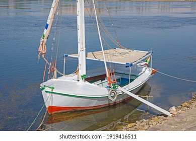 Traditional Wooden Felluca Sailing Boat Moored On Tropical River Bank With Gang Plank