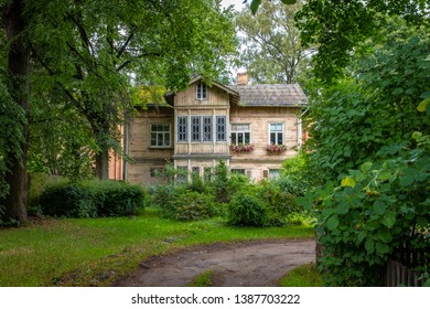 Traditional Wooden House Of An Ancient Suburb, Set In A Luxuriant Garden, Taken During An Overcast Morning, Riga, Latvia