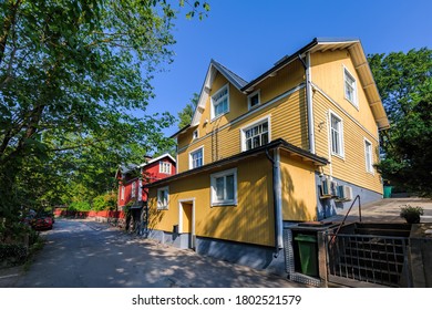 Traditional wooden house painted in traditional falun red and yellow with white window at street of Pargas town (Parainen in Finnish) in Finland at sunny summer day.