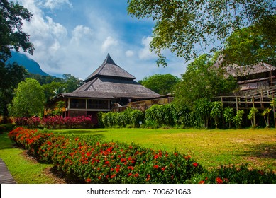 Traditional Wooden Houses In The Kuching To Sarawak Culture Village. Landscape With A Mountain On The Horizon. Borneo, Malaysia