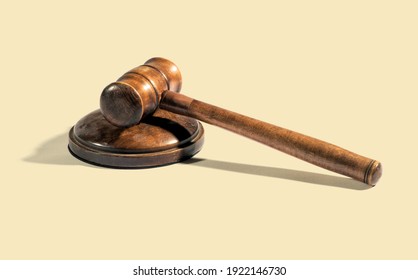 Traditional wooden judge gavel placed on round block on beige background during court