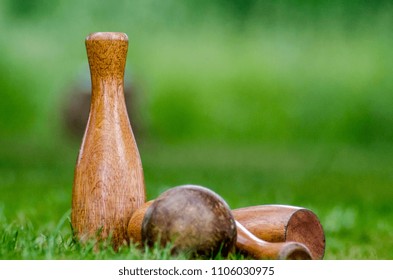 A Traditional Wooden Lawn Skittles Set On Out Of Focus Grass