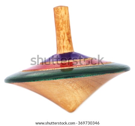 Traditional wooden spinning top of Indian subcontinent over white background