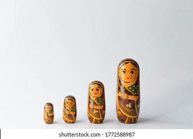 Traditional wooden toys kept in ascending/descending order based on size. Female Indian woman figurines made in Channapatna. Activities that help in mental development for kids