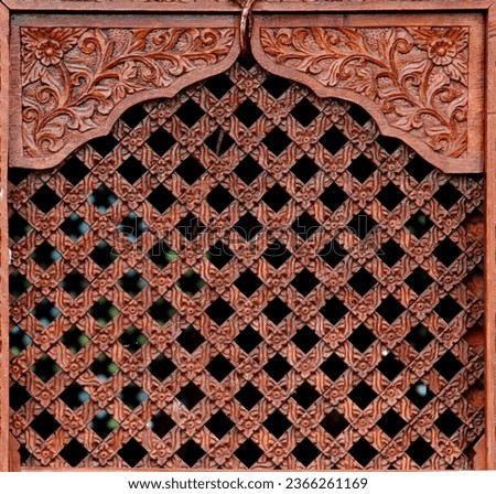 Traditional Wooden Window textured background, Wood Carved Wall or Ceiling Panel, pattern photography. Wooden window carved details on a Hindu temple. Ancient window texture.