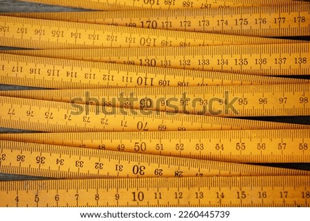 Traditional yellow wooden folding rule with decimal metric system