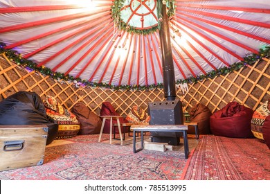 Traditional Yurt interior. Glamping with fire place for rest and company.