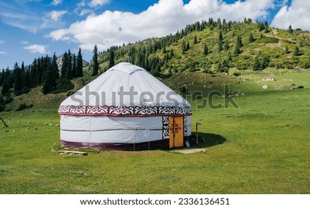 A traditional Yurt in Kyrgyzstan. National old house of the peoples of Kyrgyzstan and Asian countries. national housing. Yurts on the background of green meadows and highlands.