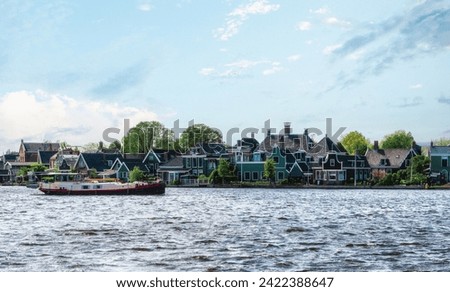 Traditional Zaan houses with the painted wooden facades on the banks of the river Zaan, The Netherlands
