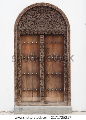 Traditional Zanzibar door with spikes. Indian door style.	