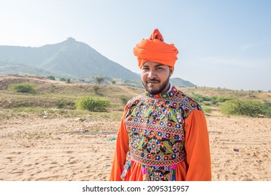 Traditionally dressed tourist Sagar Mhaske closeup in Pushkar Camel Fair, India.