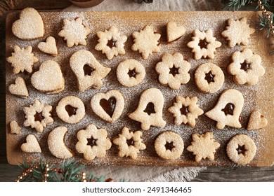 Traditonal homemade Linzer Christmas cookies filled with marmalade and dusted with sugar, top view - Powered by Shutterstock