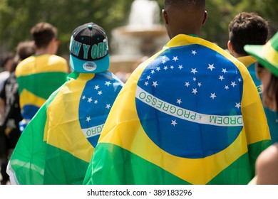 Trafalgar Square, London, UK. 12th June 2014. EDITORIAL - Brazil Day, a celebration for the start of the 2014 FIFA World Cup. Spectators at Brazil Day wearing the Brazilian national flag.