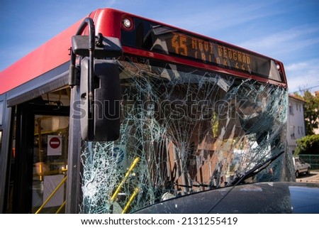 Traffic accident involving public transport trolleybus or city bus. Unbreakable frontal glass damaged by crash. Close up. Translation: 