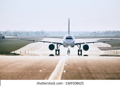 Traffic at airport. Front view of airplane on taxiway after landing. 