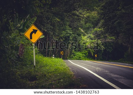 Traffic alerts downhill slope. Reduce speed and use a lower gear.arrow traffic sign with blue sky.warning sign on the street.