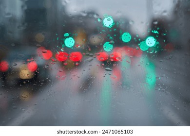 Traffic in bad weather. Windshield with raindrops. Green traffic light. - Powered by Shutterstock