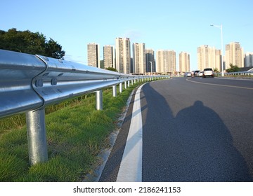 Traffic barrier on bridge highway road.  protect vehicles from accident.  guardrails.  Industrial city background.