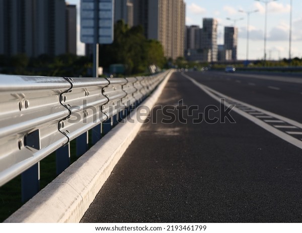 Traffic barrier on bridge highway road.\
Median crash barriers for protect vehicles from accident. \
Industrial city\
background.