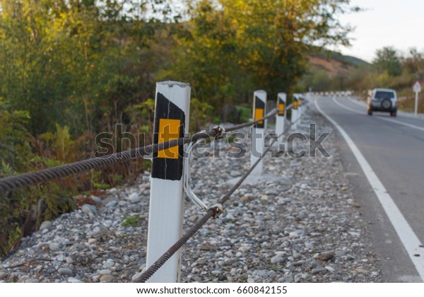 Traffic Barrier, safety\
road on road. Close up asphalt road texture with white stripe. The\
car on the road