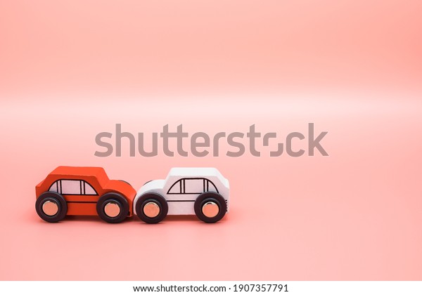 Traffic car toy accident and insurance\
concept on pink background. Agent examines and reports damage\
vehicle to collide broken on the road. Investigation driver\
indemnity claim crash\
transportation.