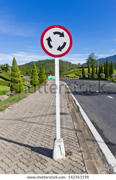 Traffic Circle Sign with Blue Sky Background in a\
Bright Day.