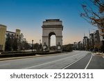 traffic in the city near the Triumphal arch at the Millennium Gate Museum with cars on the street and autumn colored trees in downtown Atlanta Georgia USA