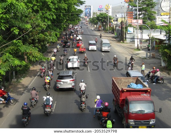 traffic conditions on the main road in\
the morning many workers\' vehicles are ready to go to the office.\
Semarang Central Java Indonesia - October 6th\
2021