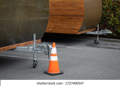 Traffic Cone Beside The Trailer Hitch To A Caravan Camper, With Space For Text On The Right