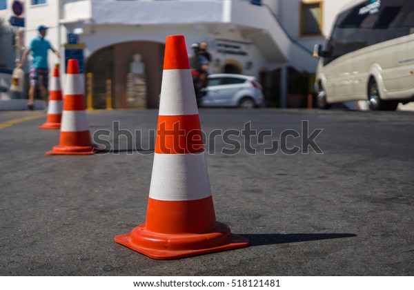 Traffic cone for traffic control. Focus on\
the foreground.