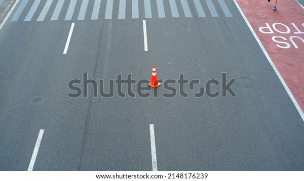Traffic cone in the\
middle of the road 