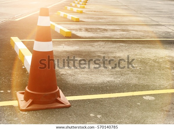 Traffic cone\
on the road with flare light\
background