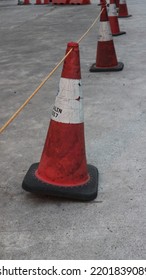 Traffic Cone On The Side Of The Road That Looks Old And Dull.