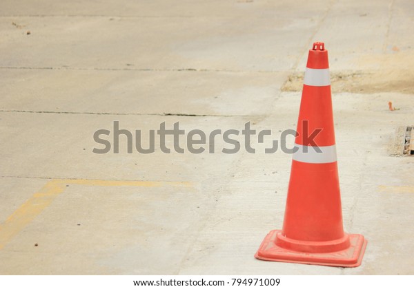 traffic cone safety\
sign standing on road