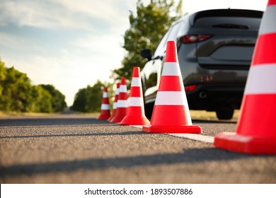 Traffic cones near car outdoors. Driving school exam - Shutterstock ID 1893507886