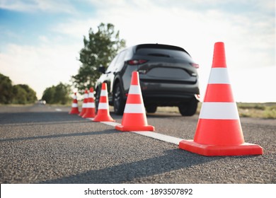 Traffic cones near car outdoors. Driving school exam - Shutterstock ID 1893507892
