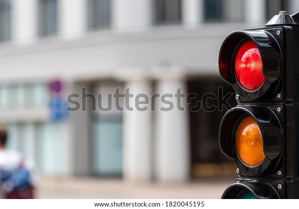 traffic control semaphore with stop light on a\
defocused city\
background