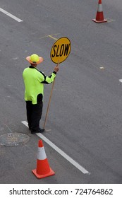 Traffic Controller With A Stop Sign On A Road Under Repair.