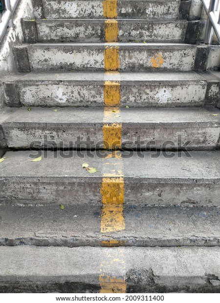 Traffic demarcation line, yellow line dividing\
lane, concrete floating\
stairs