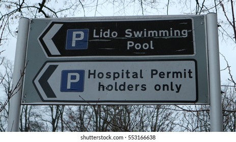 Traffic Direction Sign For Hospital Parking And Lido Swimming Pool In England 