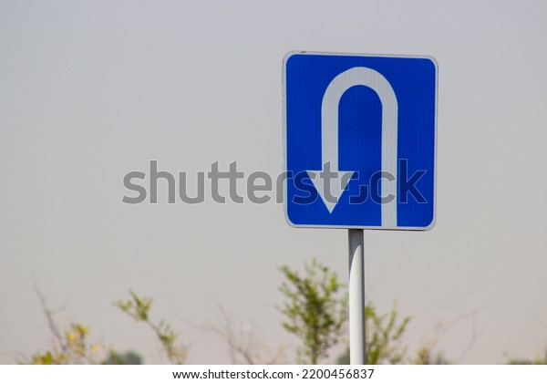 traffic direction sign white reverse arrow on\
blue background