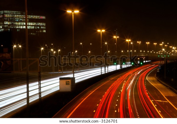 Traffic at\
full speed on a busy highway in the\
evening