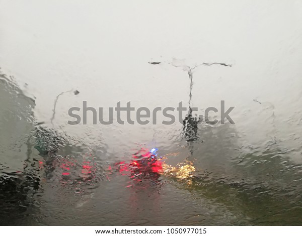 Traffic in heavy monsoon\
rain.