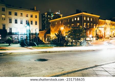 Traffic and historic buildings on Charles Street at night in Mount Vernon, Baltimore, Maryland.