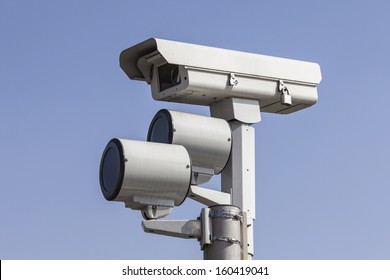 Traffic intersection signal surveillance camera with lights.