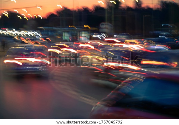 Traffic jam, colorful city and\
cars lights, blurred by speed and motion. A streak of light,\
trails.