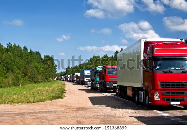 Traffic jam congestion.\
Trucks in a row. 