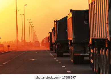 Traffic Jam of Heavy Trucks in Sunset