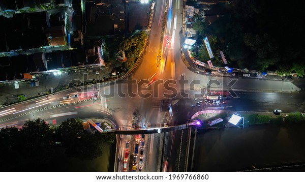 Traffic jam on the\
polluted streets of Bekasi at night. The traffic congestion is\
limited in few areas, selective focus on the road. Bekasi,\
Indonesia, May 8, 2021